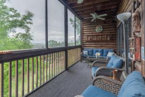 a screened in porch with chairs and windows at 2BR Village At Indian Point 705 near SDC-Free Tickets Daily up to $500 Value in Branson
