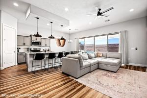 a living room with a couch and a kitchen at Game Room - Heated Pool & Spa - Fire Pit - Golf in Mesquite