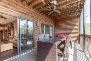 a screened in porch with a table and chairs at 2BR Village At Indian Point 902 near SDC-Free Tickets Daily up to $500 Value in Branson