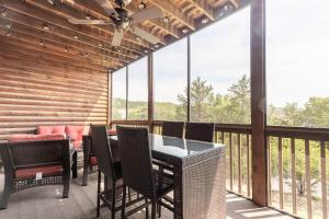 a dining room with a table and chairs on a balcony at 2BR Village At Indian Point 902 near SDC-Free Tickets Daily up to $500 Value in Branson