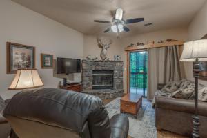 a living room with a couch and a fireplace at 2BR Village At Indian Point 803 near SDC-Free Tickets Daily (up to $500 Value) in Branson