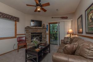 a living room with a couch and a fireplace at 2BR Village At Indian Point 1005 near SDC-Free Tickets Daily up to $500 Value in Branson