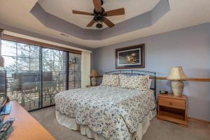 a bedroom with a bed and a ceiling fan at 2BR Village At Indian Point 1005 near SDC-Free Tickets Daily up to $500 Value in Branson +11 photos