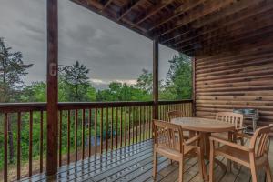 a patio with a table and chairs on a deck at 2BR Village At Indian Point 901 near SDC-Free Tickets Daily up to $500 Value in Branson