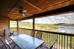 a table and chairs on a balcony with a view of the water at 2BR+Loft Village At Indian Point 1509 near SDC- Free Tickets Daily up to $500 in Branson