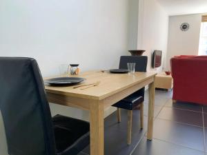 a wooden table and chairs with plates and glasses on it at Yardley Lodge in Birmingham