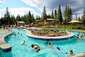 a group of people in a pool at a water park at Mt. Bachelor & Sun River Get Away in Bend