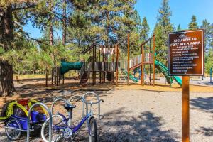 a playground with a bike parked next to a sign at Mt. Bachelor & Sun River Get Away in Bend