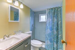 a bathroom with a toilet and a sink and a shower at 2 Mi to UBS Arena WFH-Friendly Couples Retreat in South Floral Park
