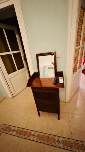a mirror on a dresser in a room with a door at apt via cernaia rome center in Rome
