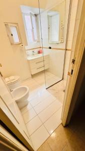 a bathroom with a toilet and a glass shower at apt via cernaia rome center in Rome