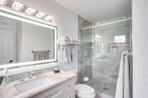 a white bathroom with a sink and a shower at Idyllic Tustin Home with Private Patio and Grill in Tustin +16 photos