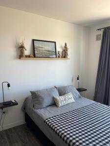 a bedroom with a bed and a shelf on the wall at Roma in Belén de Escobar