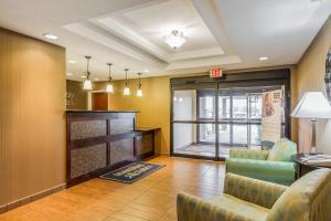 a lobby with a waiting room with chairs and a window at MainStay Suites Grand Island in Grand Island
