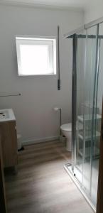 a white bathroom with a toilet and a window at Baleal Atlantic 10 in Baleal +17 photos