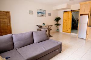 a living room with a couch and a table at Rosarito beachside apartment in Rosarito Beach