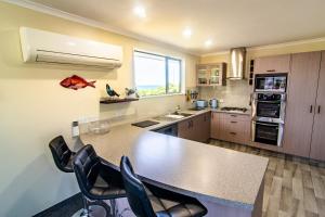 a kitchen with a large table and chairs in it at Close to Beach, Spacious, Outdoor Living - KK00379 in Kaikoura