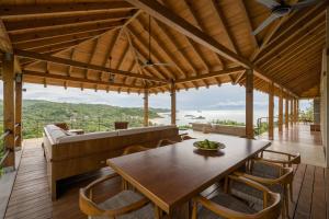 a living room with a wooden table and chairs at Casa Queña, in the heart of Mazunte in Mazunte