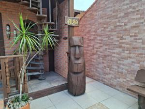 a wooden sign on the side of a brick building at Toca do Moa in Florianópolis