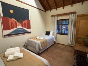 a bedroom with two beds and a window at Carmela Inn in Monte Grande