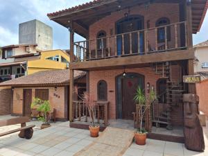 a brick building with a balcony on top of it at Toca do Moa in Florianópolis