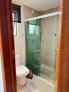 a bathroom with a glass shower with a toilet at Aldeia das Águas Park Resort - Flat B309 Quartier in Barra do Piraí