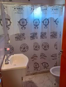 a bathroom with a shower curtain and a sink at Agua de Oro antistress cabana in Agua de Oro +23 photos