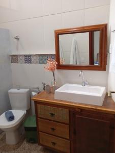 a bathroom with a sink and a toilet and a mirror at casa de mineiro in Tiradentes +35 photos