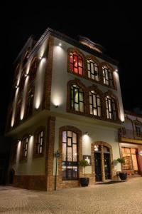a building with a red light in the windows at BHB Boutique House in Macedo de Cavaleiros
