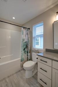 a bathroom with a toilet and a shower curtain at Gardener's Getaway in Ocean Shores +32 photos