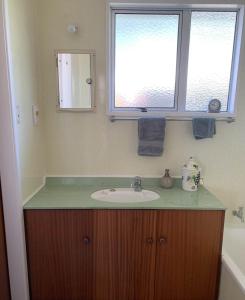 a bathroom with a sink and a window at Relax and rewind at Waihi Beach with Oberon Bach in Waihi Beach +9 photos