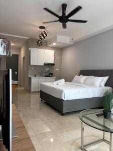 a bedroom with a large bed with a ceiling fan at ICC Suites Ipoh City Centre in Ipoh +41 photos