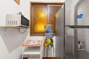 a kitchen with a refrigerator and a bottle of water at Spacious House 3 Bedrooms Perfect for Families in Casa Blanca La Corregidora