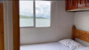 a bedroom with a window looking out at the water at El Ismael de Jaguas in San Rafael