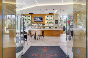 a restaurant with a counter and tables and chairs at Infinite View Balcony - Amazing Pool - Gym in Hallandale Beach