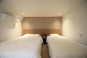 Postel nebo postele na pokoji v ubytování Soho Hotel