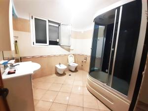 a bathroom with a toilet and a sink and a shower at Villas Mari-Anna for rent best view in Durrës +33 photos