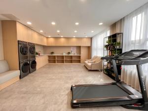 上海Shanghai Joyful Star Hotel-Free shuttle bus to Pudong Airport and Disneyland的一间带跑步机和洗衣机的健身房