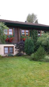 a house with flowers on the side of it at Ferienhaus Vulkaneifel Bei Hepp in Schönbach