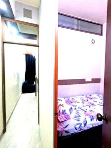 a door leading to a bed in a room at Utopia Guest house for men in New Town