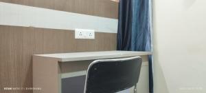 a desk with a black chair in a room at Utopia Guest house for men in New Town