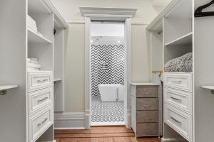 a bathroom with white cabinets and a walk in shower at SWJ544FH Huge 6BR 4BA Backyard Access in New York +81 photos