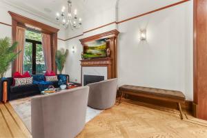 a living room with two chairs and a fireplace at SWJ544FH Huge 6BR 4BA Backyard Access in New York