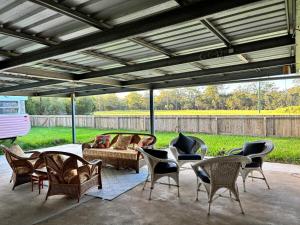 a patio with a couch and chairs and a table at Lenlie Farm in Howard