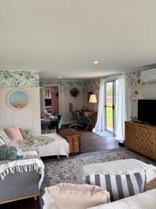 a bedroom with two beds and a living room at Lenlie Farm in Howard