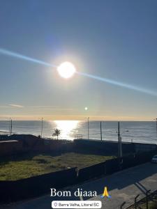 a view of the ocean with the sun in the sky at Pousada Souza & Souza in Barra Velha