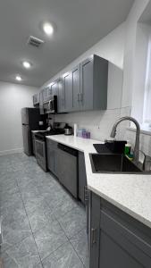 a kitchen with stainless steel appliances and a sink at Beautiful Bedroom with Attached Bathroom, 15 minutes from NYC in West New York