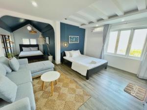 a living room with a couch and a bed at 4 Bedrooms Beach Villa in Central Vung Tau in Vung Tau +25 photos