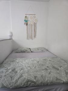 a bedroom with a bed and a clock on the wall at Studio au calme rive droite in Palavas-les-Flots