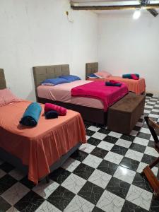 three beds in a room with a checkered floor at Rancho Ohana in Peruíbe +61 photos